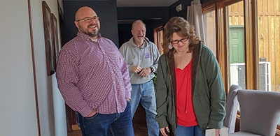 Cori and Ellen Young, owners of Young Electric in Wichita, talking with Phillip Elders about a recent commercial electrical project. 